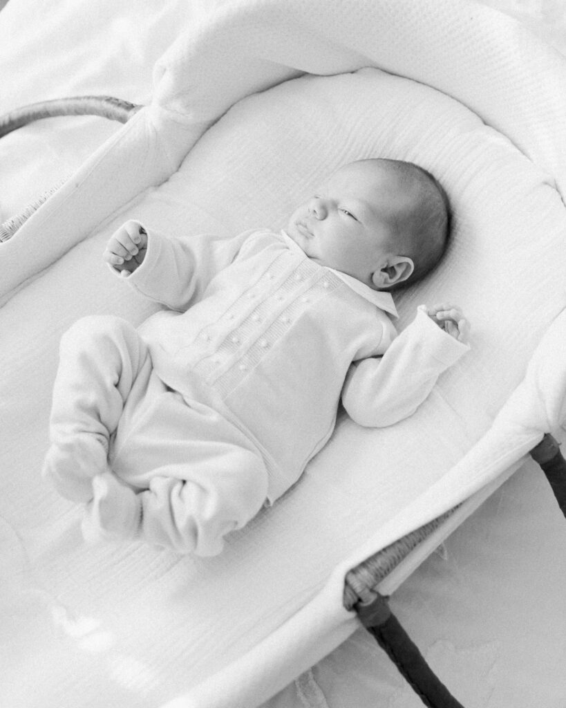 Baby Liam resting in a bassinet during an in-home newborn photography session in Montgomery, Texas.