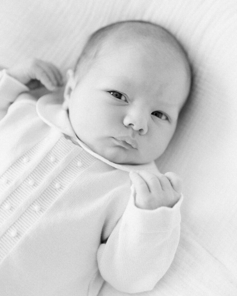 Awake newborn baby looking toward the camera during a lifestyle newborn session in Montgomery TX.