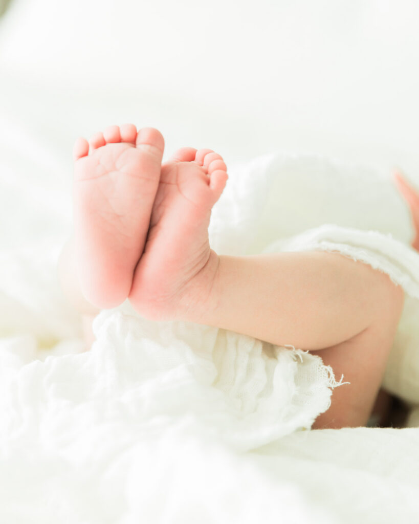 Close-up photograph of newborn baby feet during a lifestyle newborn photography session.