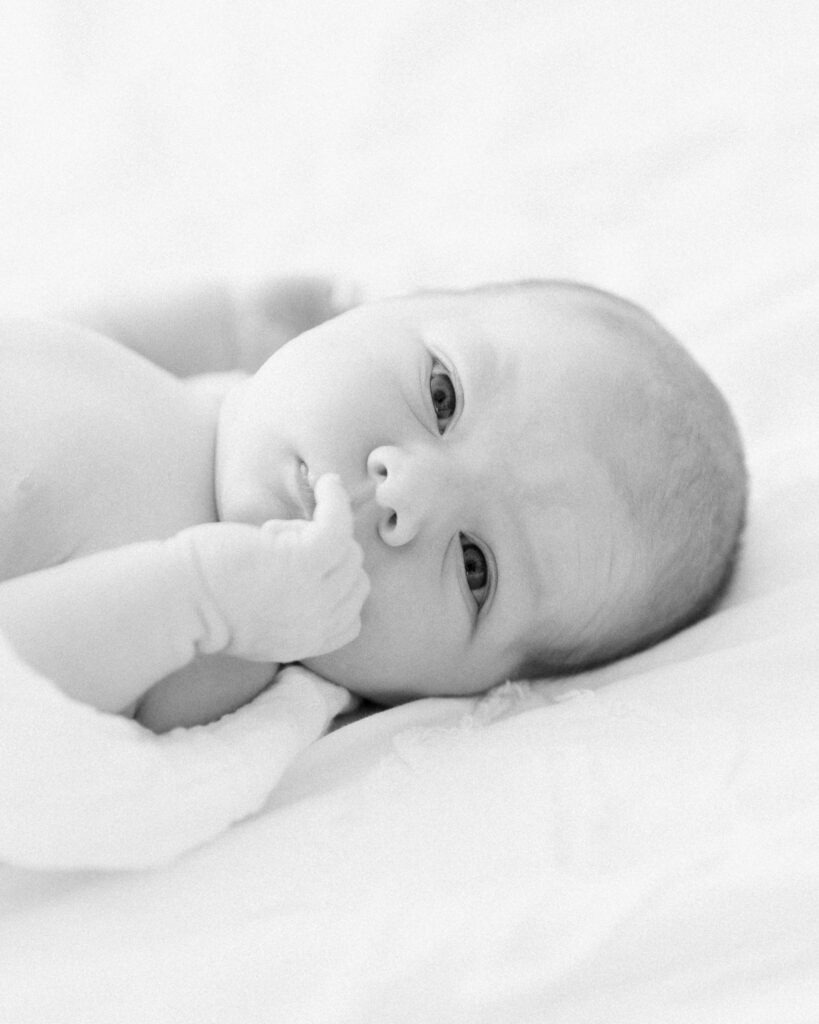 Awake newborn baby making eye contact with the camera during an in-home newborn session in Montgomery Texas.